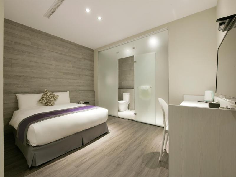 Postel nebo postele na pokoji v ubytování Hotel Hesper HSR Taichung