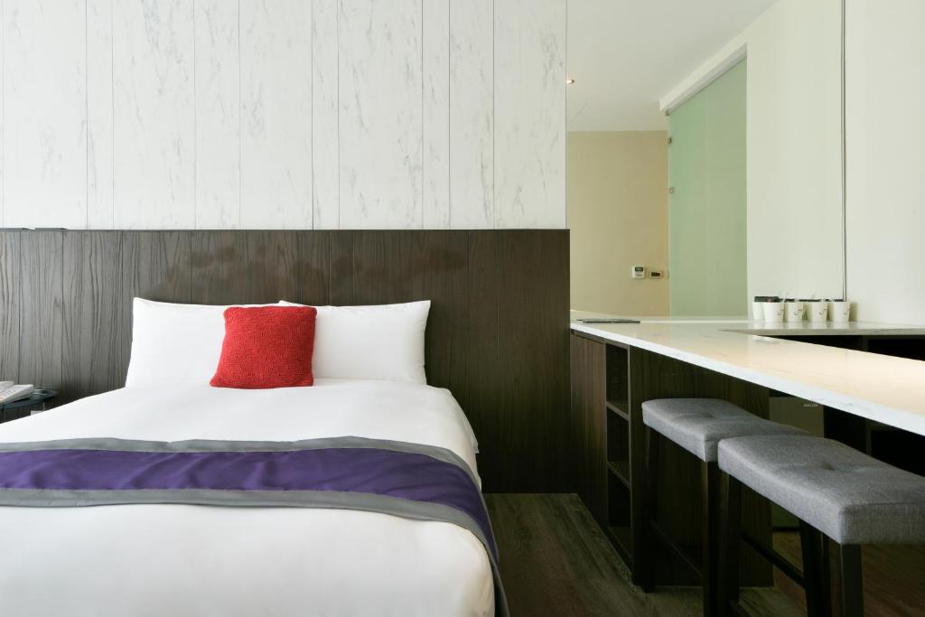 Postel nebo postele na pokoji v ubytování Hotel Hesper HSR Taichung