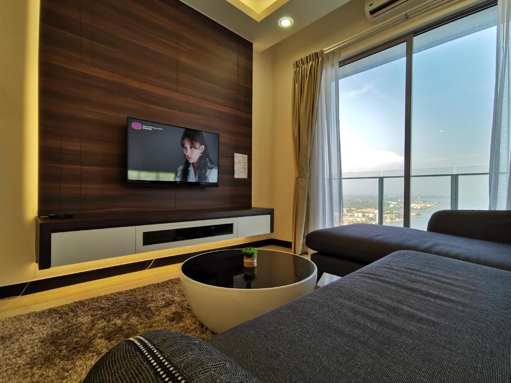 a living room with a tv on a wall at Thermospace Silverscape A-19-01 Melaka City in Melaka