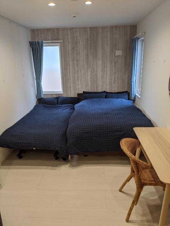 Postel nebo postele na pokoji v ubytování Port House Shibuya