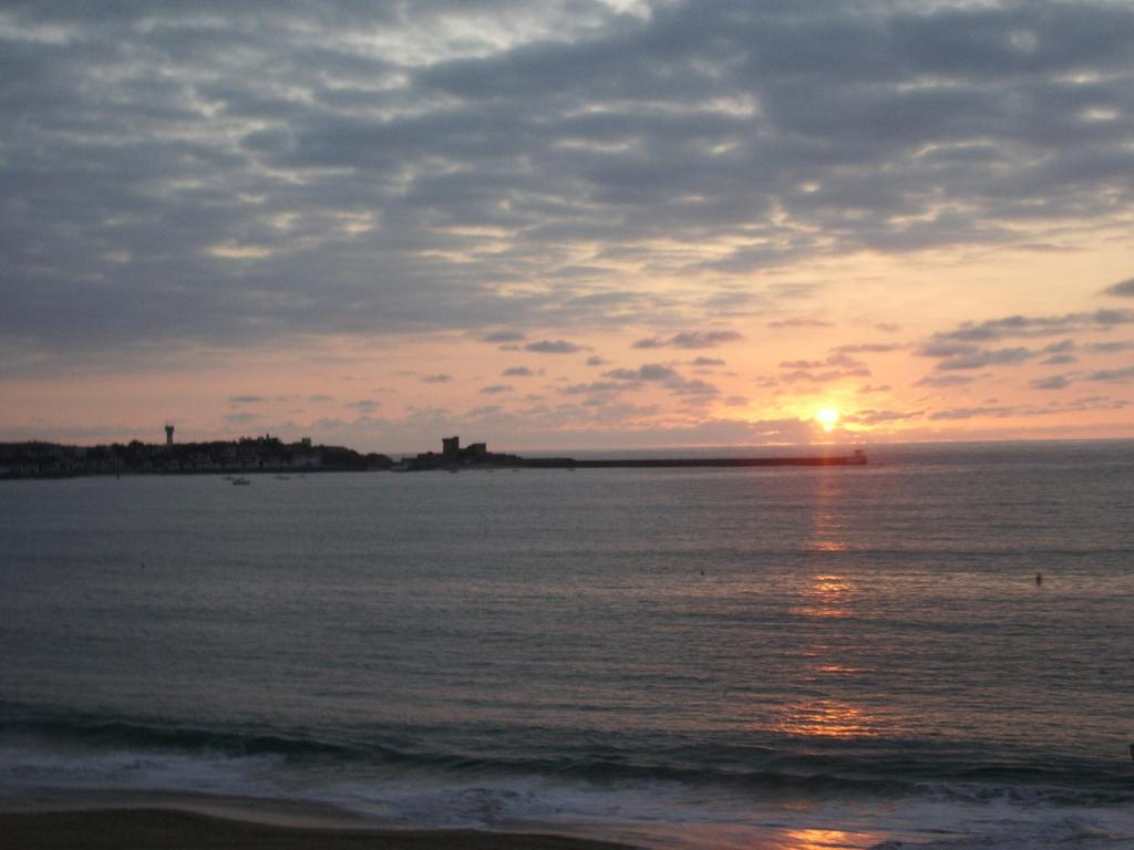 a sunset over the ocean with the sun setting at Hotel Bel Air in Saint-Jean-de-Luz