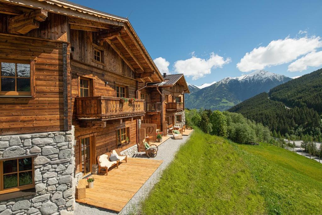 a log house with a porch and a balcony at Herzwies in Bad Hofgastein