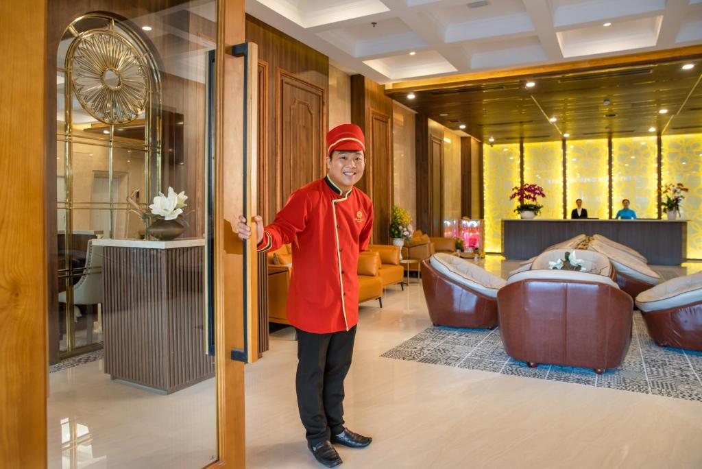 A uniformed doorman welcomes guests at the lobby entrance.