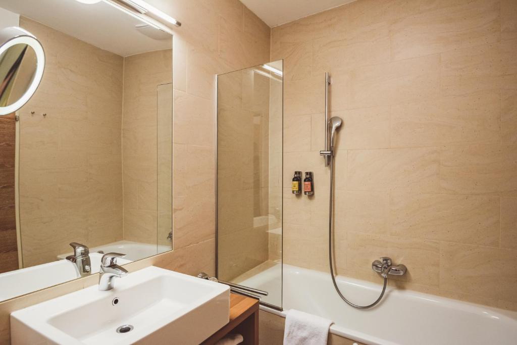 a bathroom with a sink and a shower at Heritage Hotel Hallstatt in Hallstatt