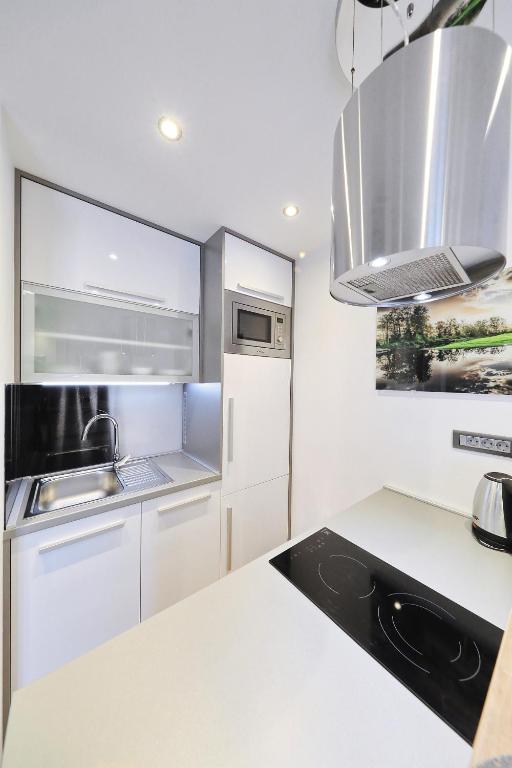 a kitchen with white cabinets and a counter top at Villa Dalmatino in Pakoštane