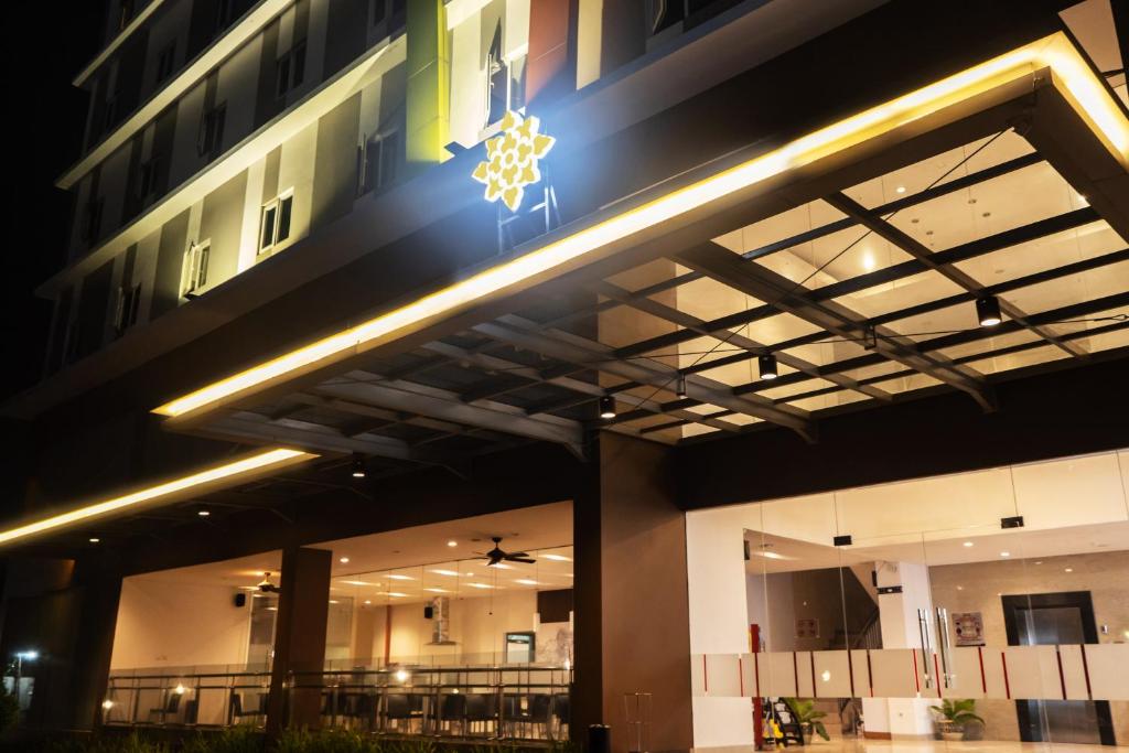a building with a christmas star on the side of it at Lynn Hotel Serang in Serang