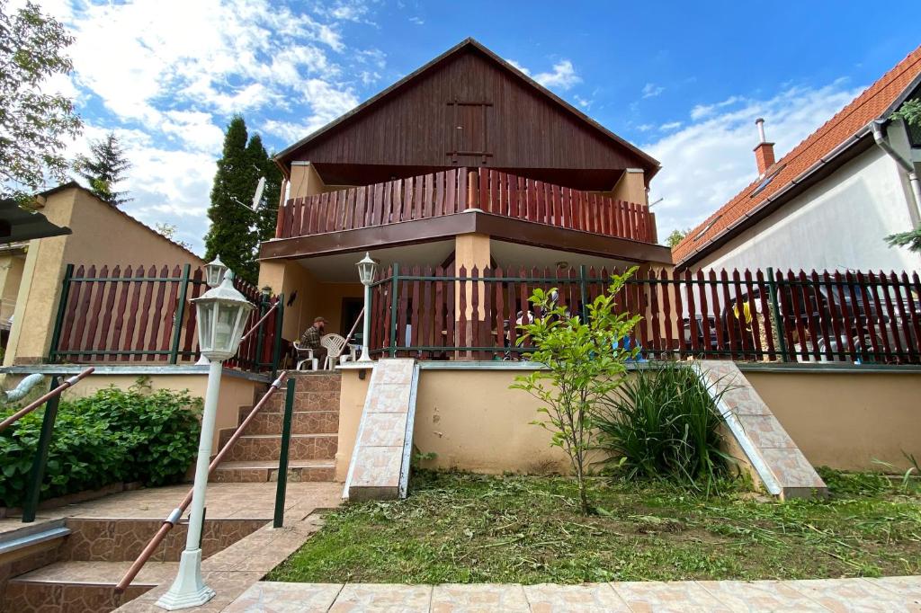 ein Haus mit einer Treppe, die auf einen Balkon führt in der Unterkunft Jászay vendégház Parádsasvár in Parádsasvár