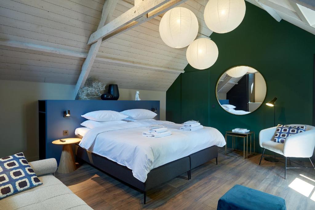 um quarto com uma cama grande e uma parede verde em The Guest Apartments - Uilenburg em Den Bosch