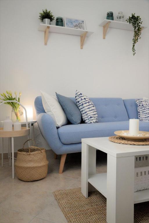a living room with a blue couch and a table at Casa di Felicita in Biograd na Moru