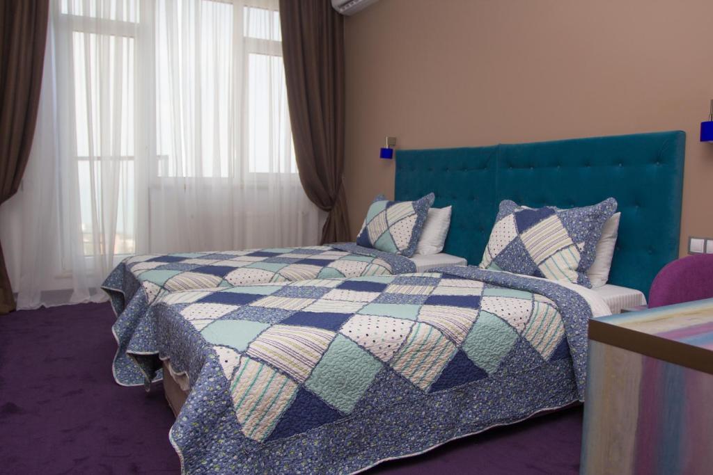 Postel nebo postele na pokoji v ubytování Horizon Hotel