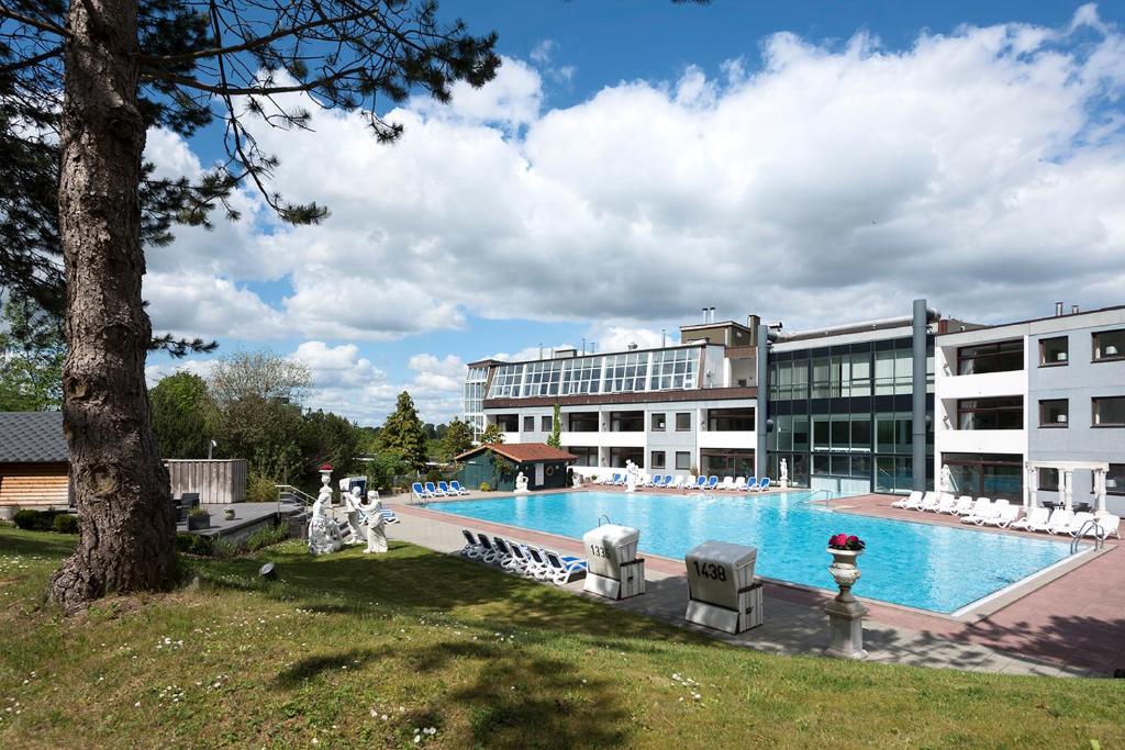 a large swimming pool in front of a building at Hotel des Nordens in Flensburg