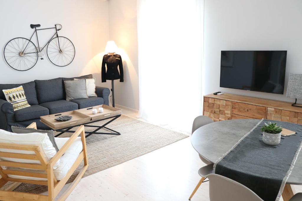 A television and/or entertainment centre at HABITAT Nafplio bnb - Design Apartment