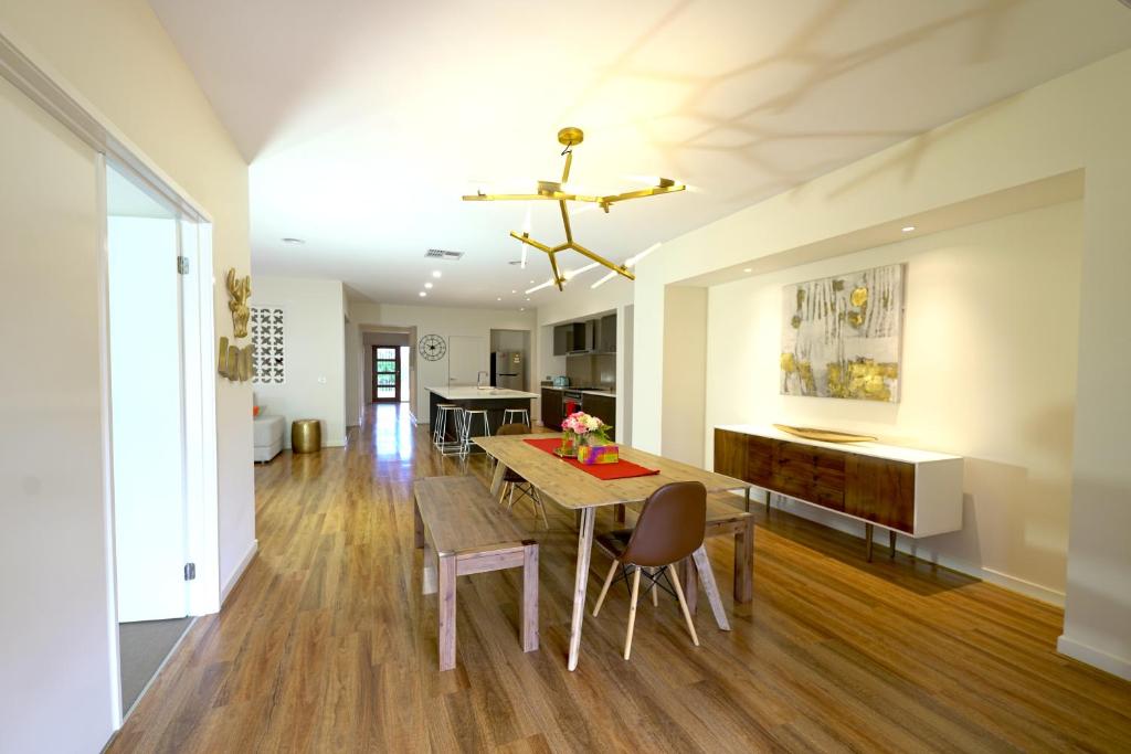 a kitchen and dining room with a table and chairs at Stylish Luxe House For Big Group Near Shopping Center in Point Cook