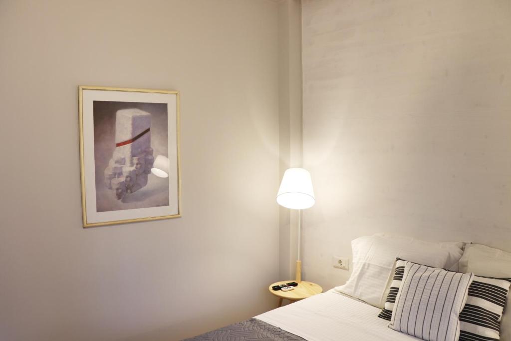 A bed or beds in a room at HABITAT Nafplio bnb - Design Apartment