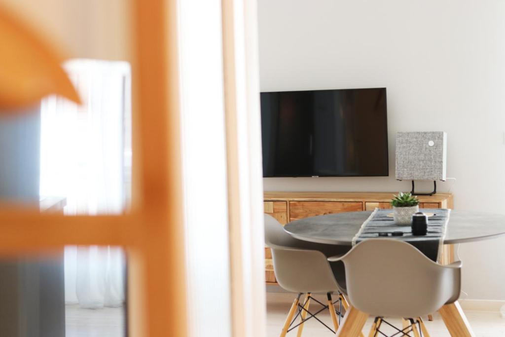 A television and/or entertainment centre at HABITAT Nafplio bnb - Design Apartment
