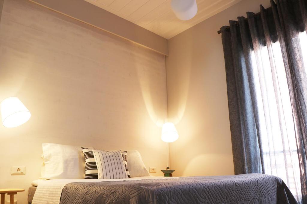 A bed or beds in a room at HABITAT Nafplio bnb - Design Apartment