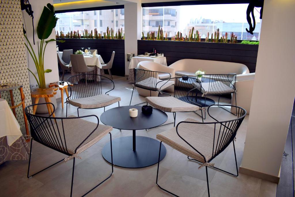 a restaurant with chairs and tables in a room at Hotel Adonis Plaza in Santa Cruz de Tenerife