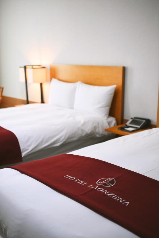 Postel nebo postele na pokoji v ubytování Hotel Laonzena
