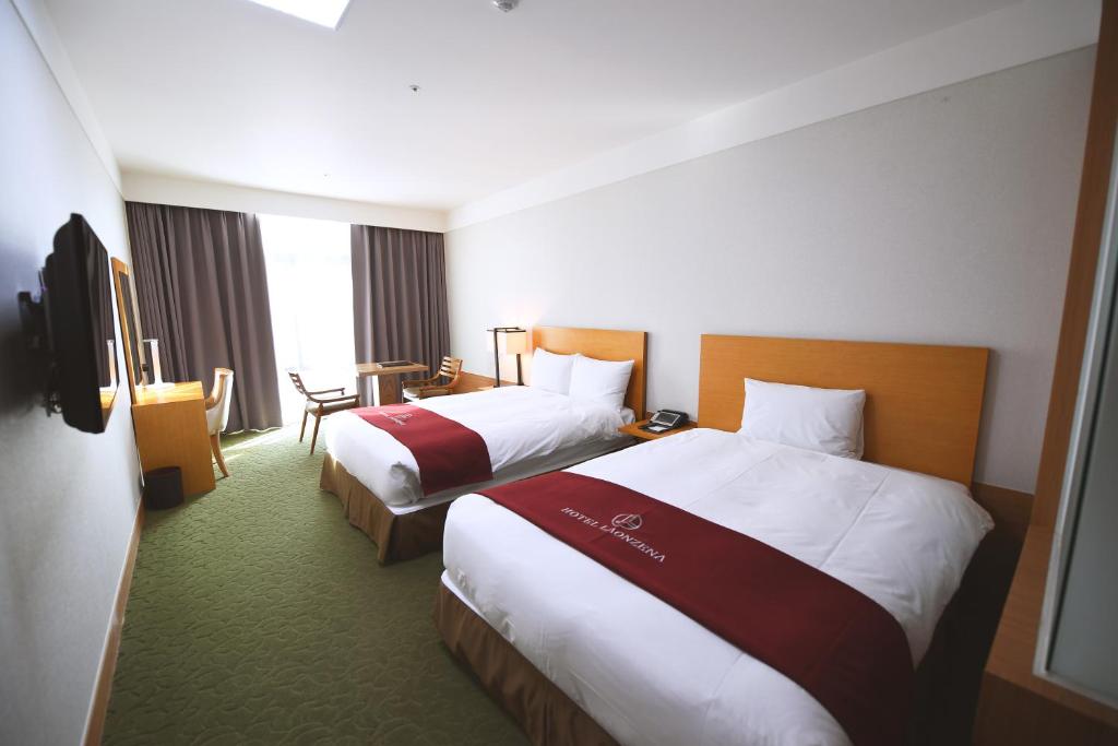 Postel nebo postele na pokoji v ubytování Hotel Laonzena