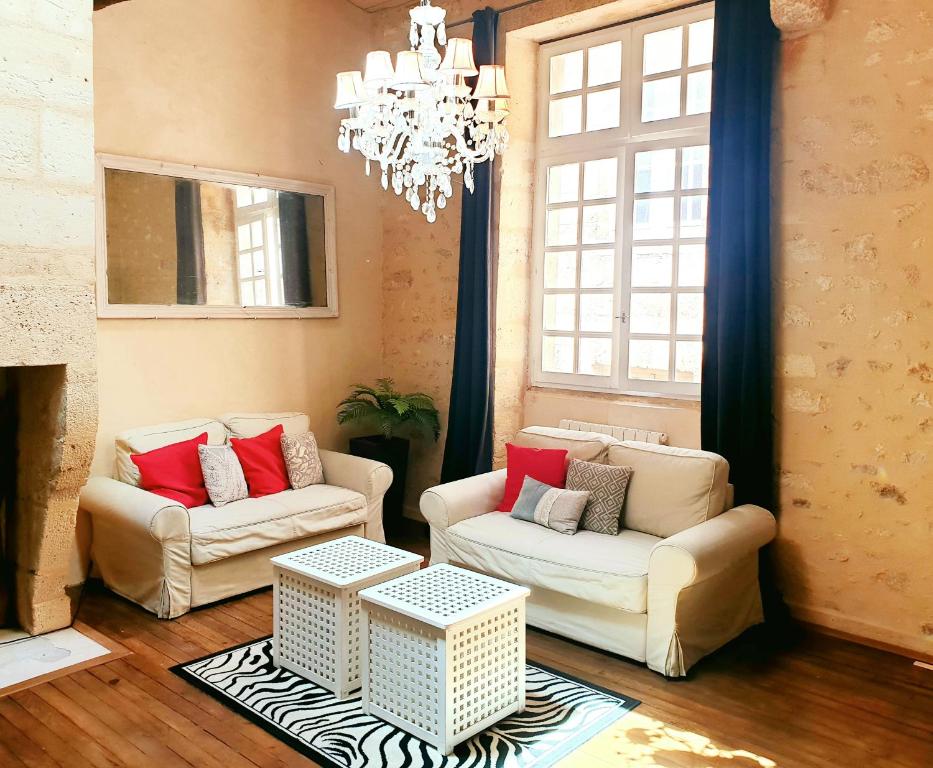 a living room with two chairs and a chandelier at Coeur de Saint Pierre in Bordeaux