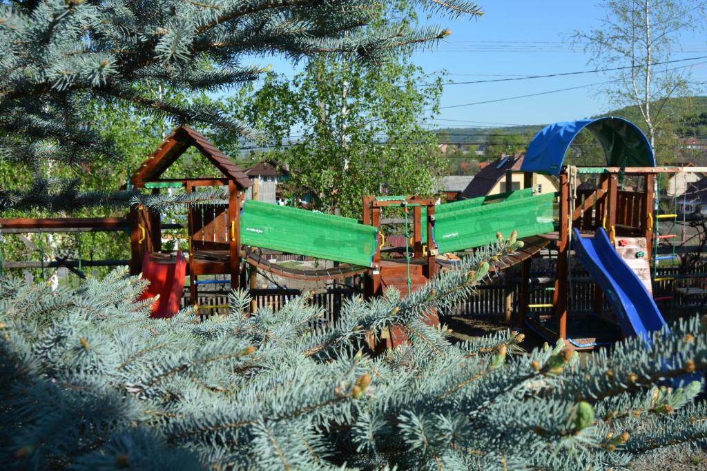 a playground with a christmas tree in the foreground at Pensiunea Moldovan in Praid