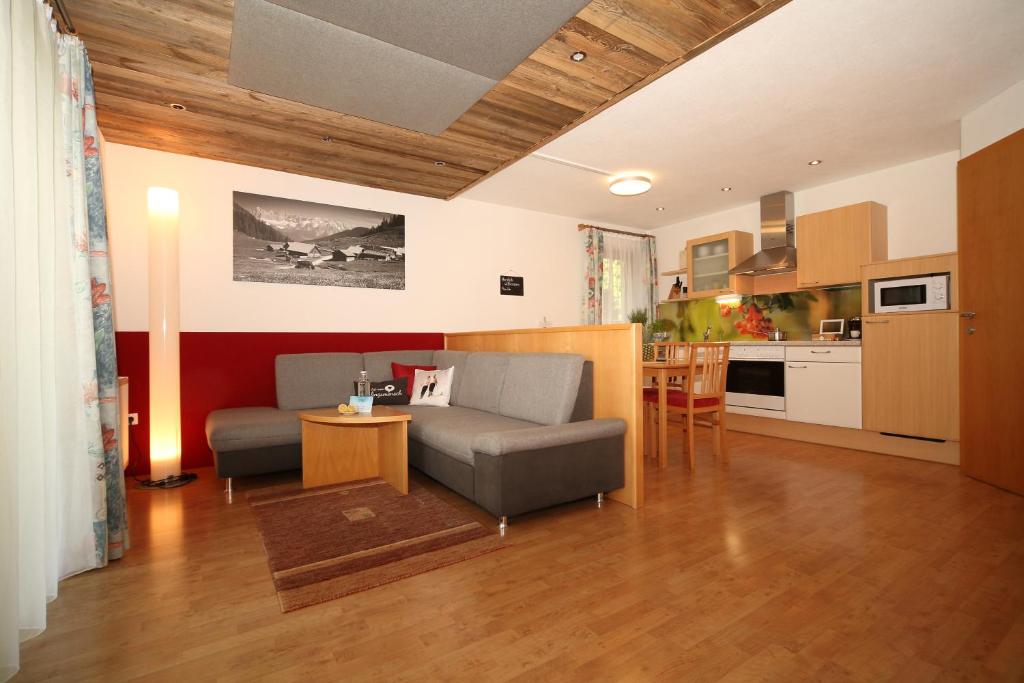 a living room with a couch and a table at Landappartement Ramsau in Ramsau am Dachstein