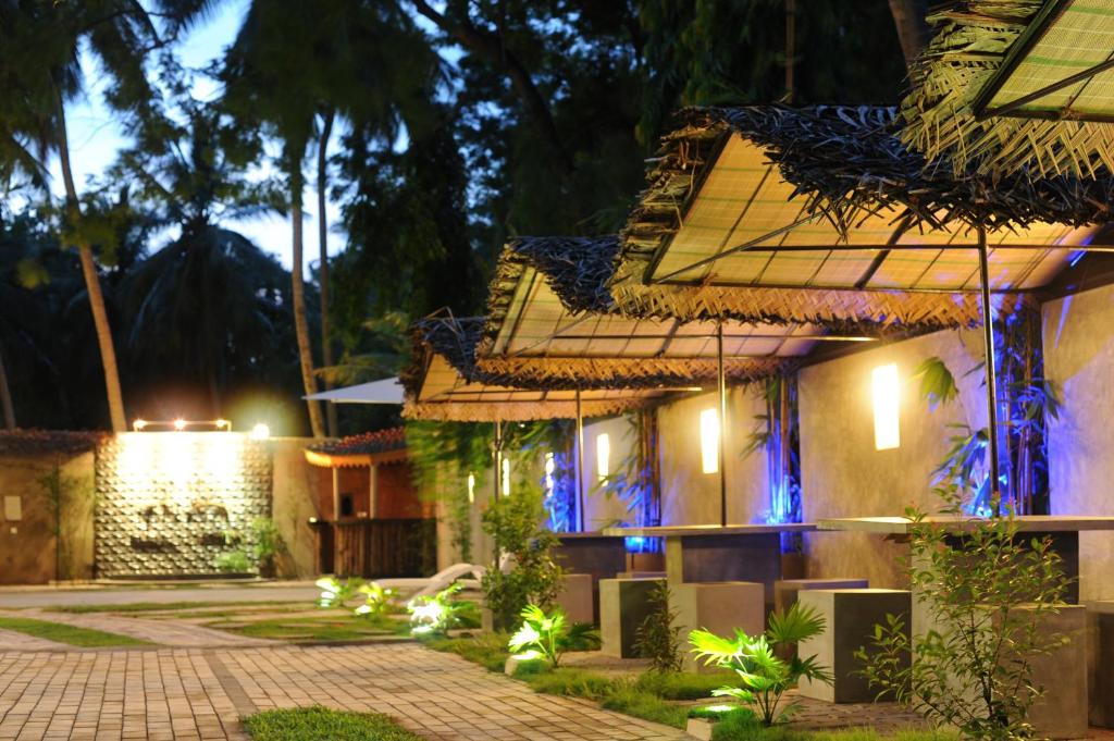 a house with lights on the side of it at night at Hotel Tinaya in Dambulla