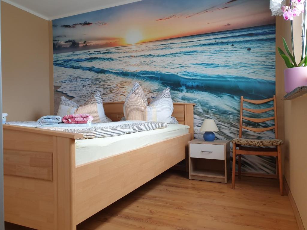 a bedroom with a painting of the ocean at Ferienhaus Scheffler in Saal
