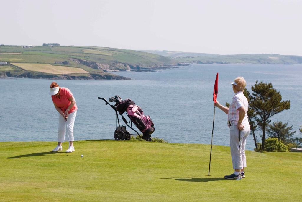 a group of people playing golf on a golf course at Dunmore House Hotel in Clonakilty