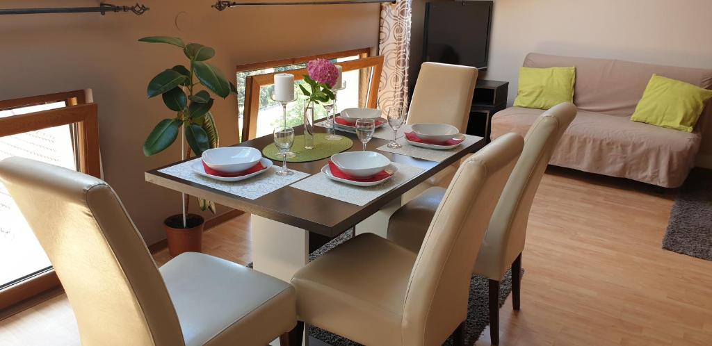 a dining room with a table with chairs and a dining room at Apatmani Milena in Opatija