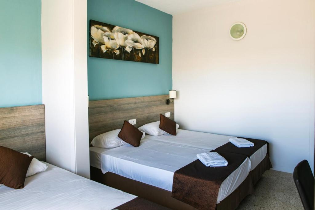 Postel nebo postele na pokoji v ubytování Beach Garden Hotel