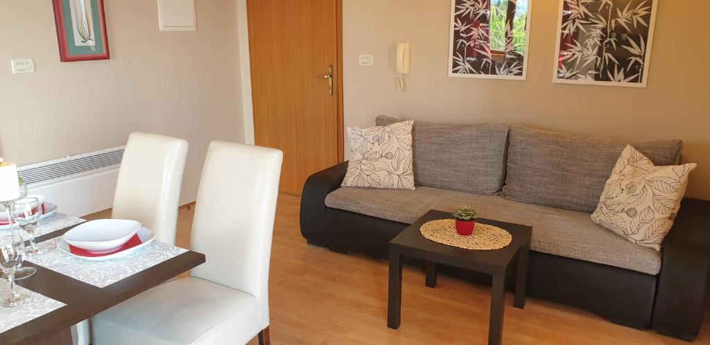 a living room with a couch and a table at Apatmani Milena in Opatija