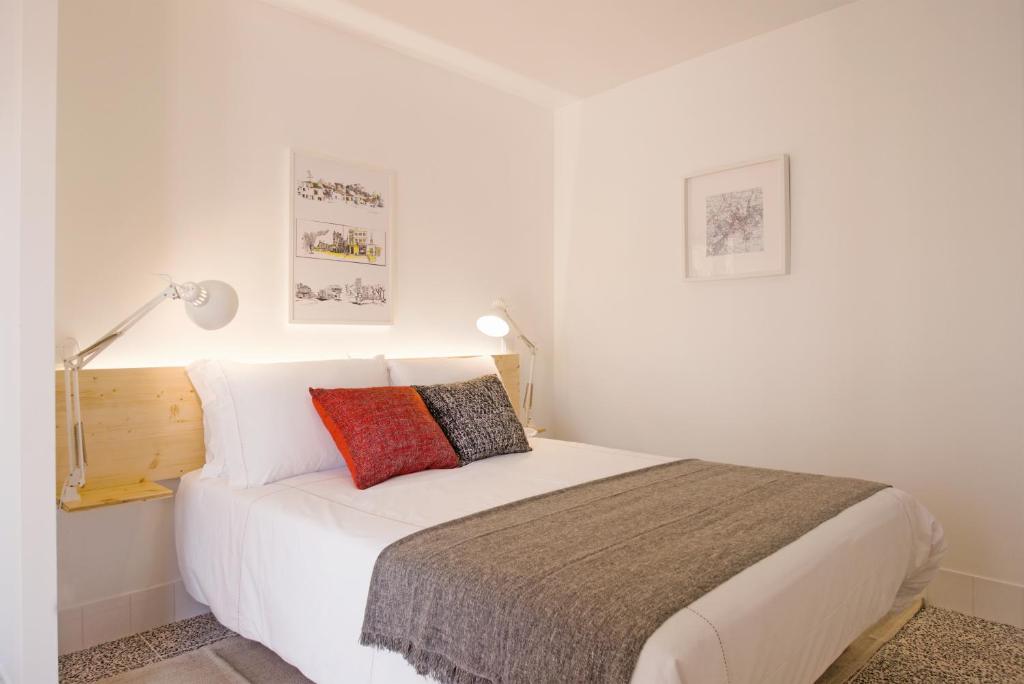 a bedroom with a white bed with two pillows at Margueda in Alcains