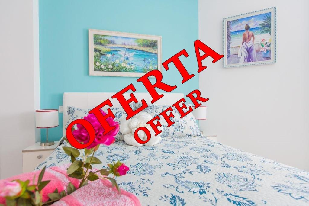 a sign that says happy offer in a bedroom at Apartamento Bella Lucia in Corralejo
