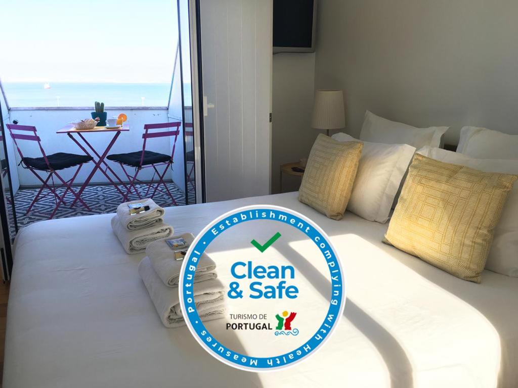 a hotel room with a clean and safe sign on a bed at Casa da Maria Alfama in Lisbon