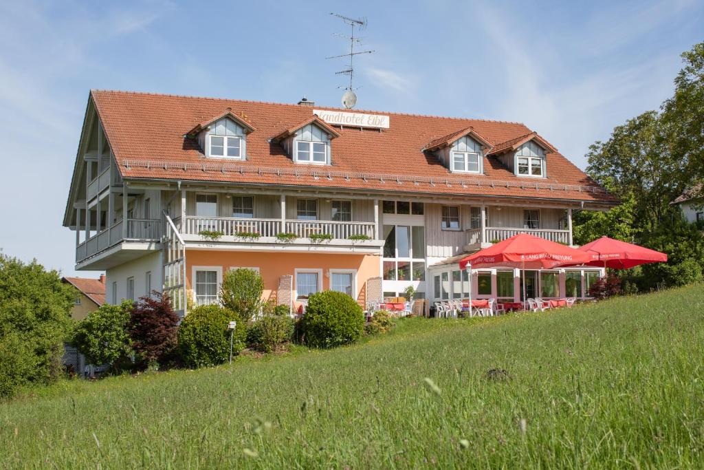 a house with a red roof and a white house at Landhotel Eibl in Röhrnbach