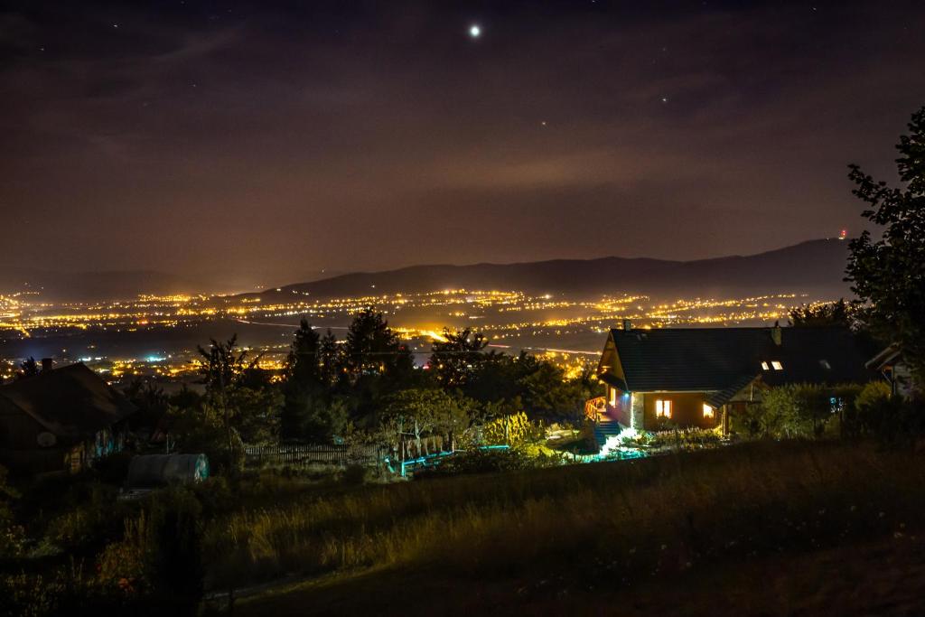 a view of a city at night at Chata na Końcu Świata in Wilkowice