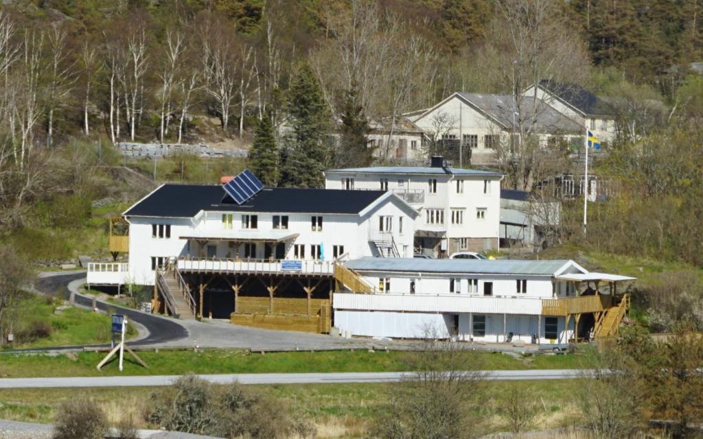 a large white house with a road in front of it at Bottna Inn in Gerlesborg