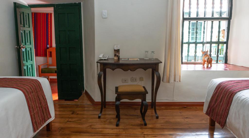 Postel nebo postele na pokoji v ubytování La Casona Real Cusco