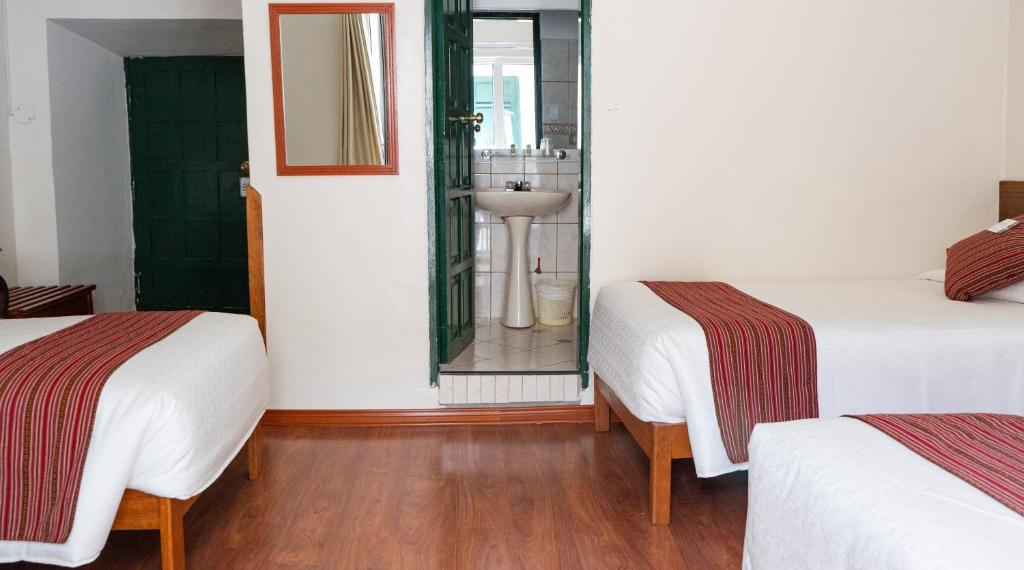 Postel nebo postele na pokoji v ubytování La Casona Real Cusco