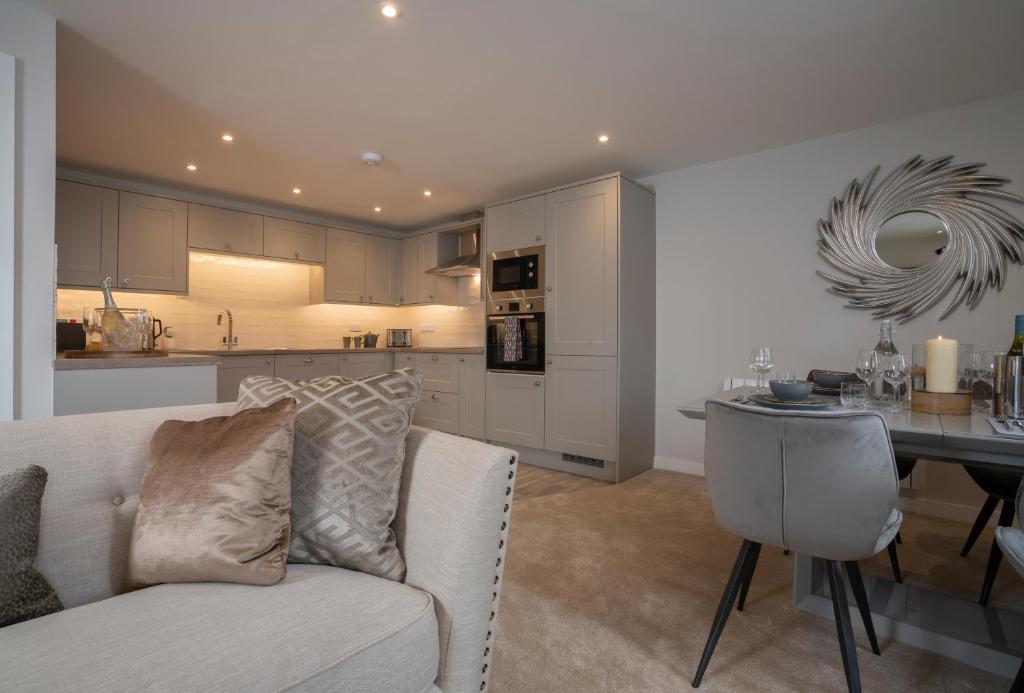 a living room with a couch and a table in a kitchen at Relaxing Home with large Terrace by LetMeStay in Ambleside