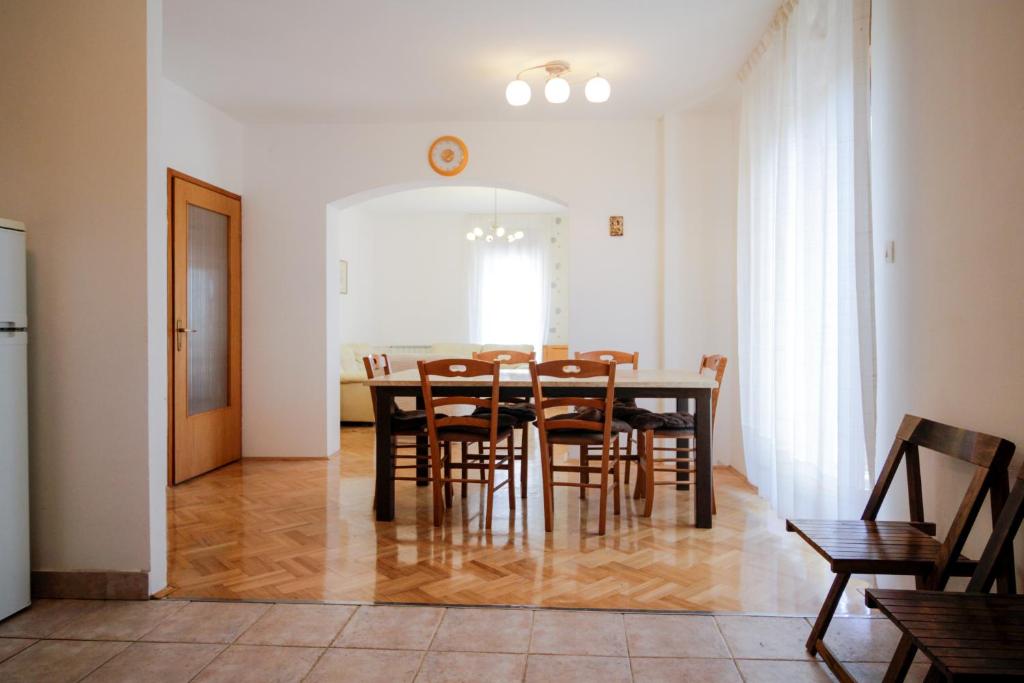a dining room with a table and chairs at Apartment Šverko in Kastav