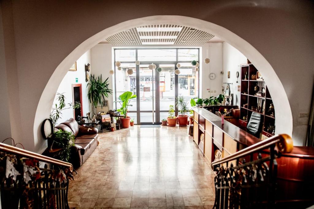 a hallway with an archway in a room with plants at Pensiunea Lms in Brăila