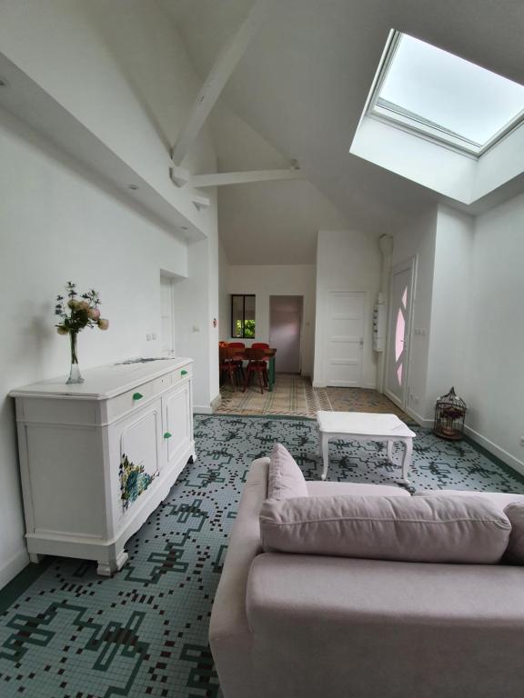 a living room with a couch and a table at Gîte de la Maison du L.A.C in Simard