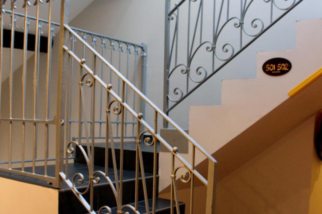 a staircase with a metal railing and a stair case at Hotel Internazionale Bellinzona in Bellinzona