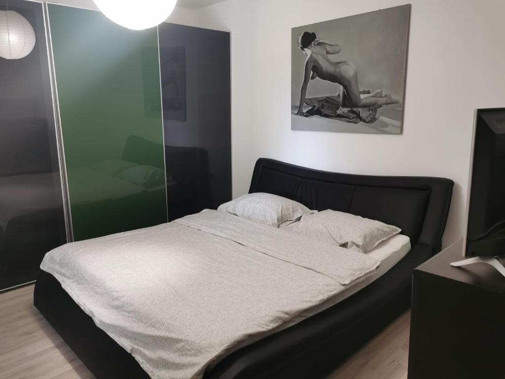 a bedroom with a bed and a woman sitting on a motorcycle at House Katarina in Ankaran