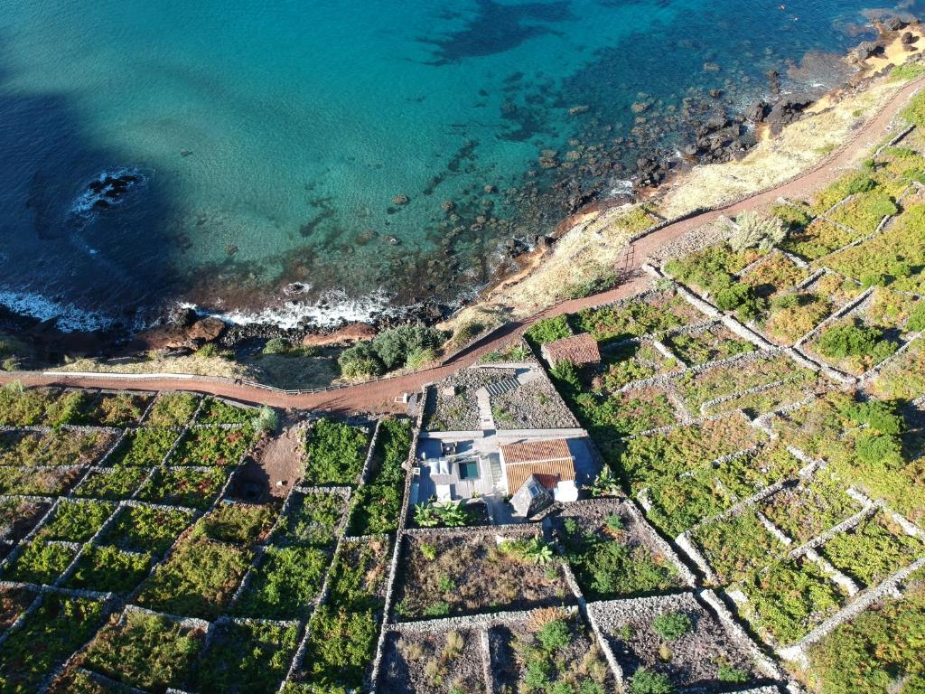 an aerial view of a house next to the water at Vigia da Areia in São Lourenço