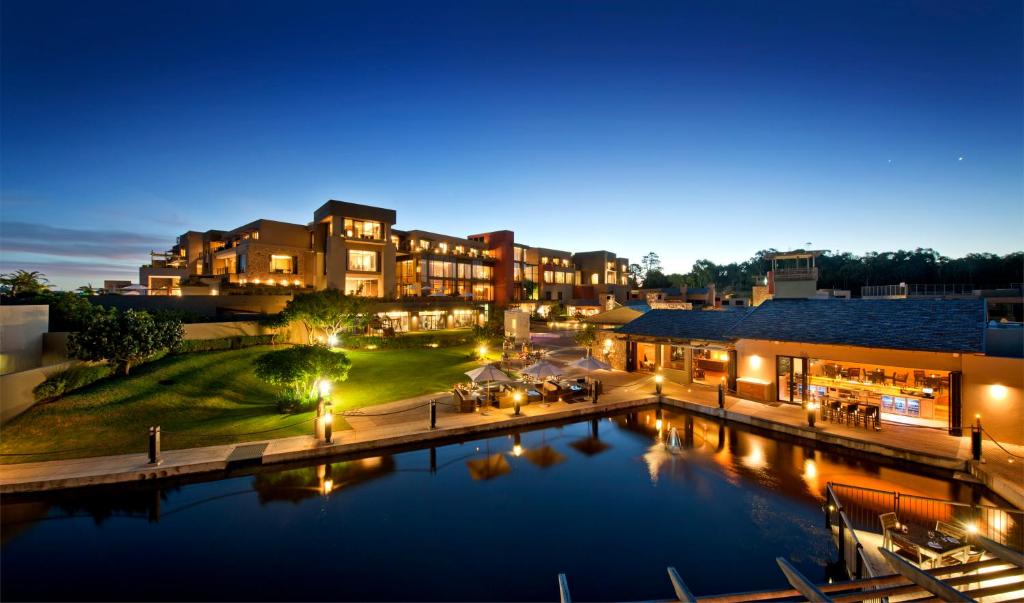 an aerial view of a hotel with a pool at night at Oubaai Hotel Golf & Spa in George