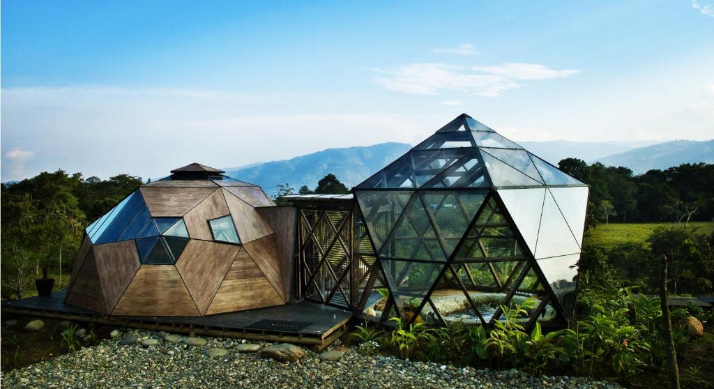 a building with a glass dome and a house at Nacimiento Glamping in San Agustín