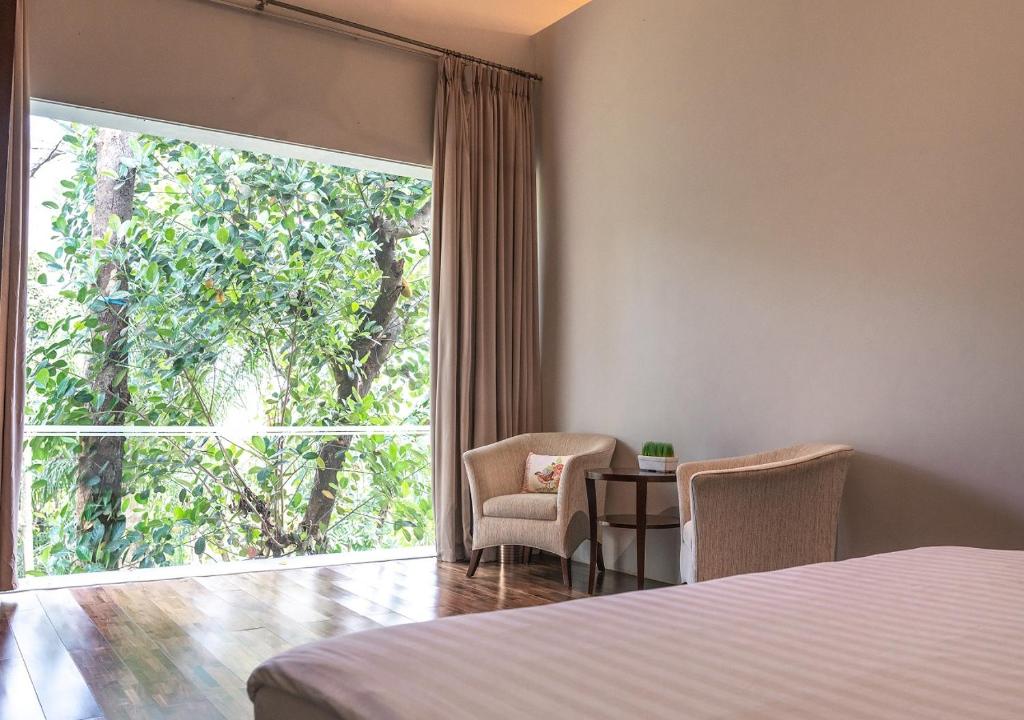 Postel nebo postele na pokoji v ubytování K Gallery Hotel